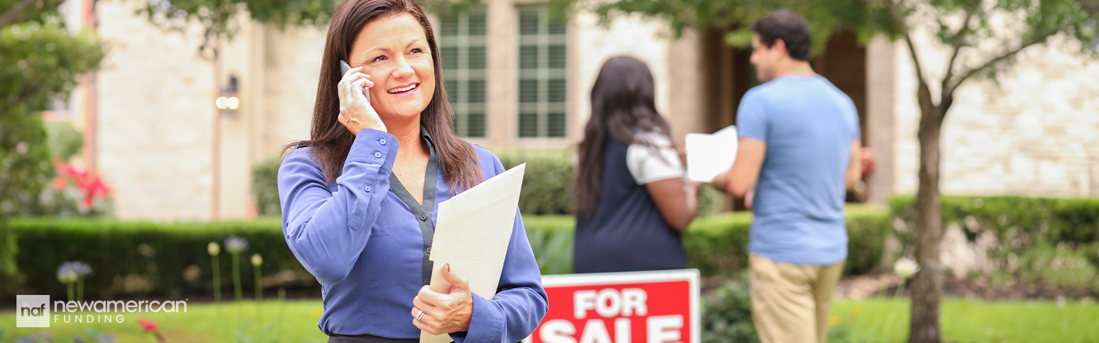 A real estate agent and a couple making an offer on a home