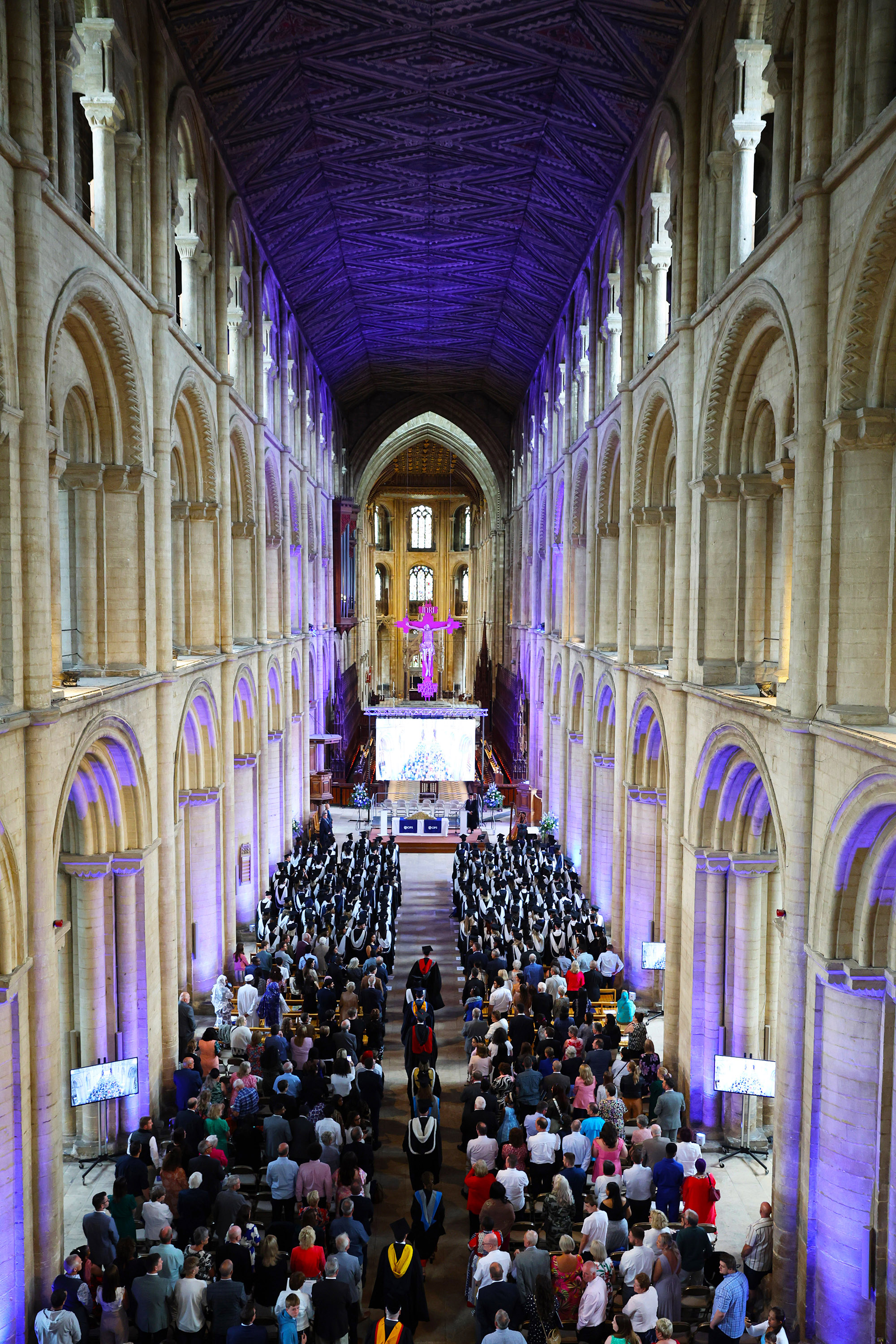 High angle view of a large graduation ceremony inside a cathedral or church