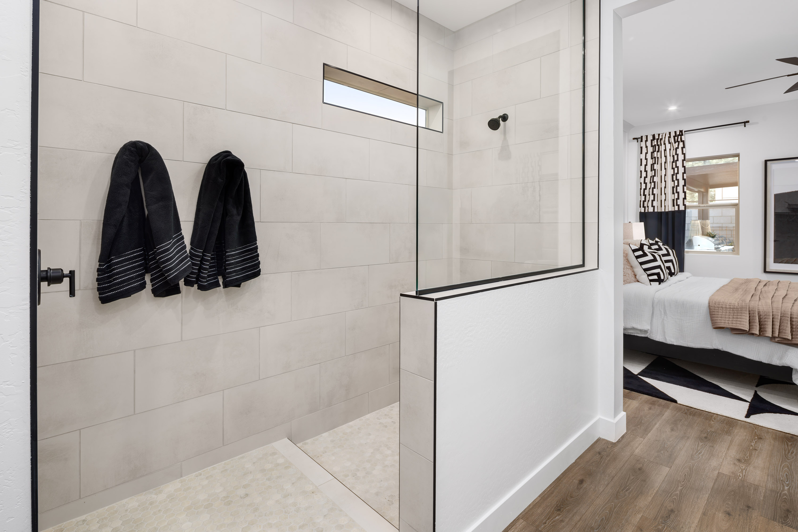 large walk-in shower with black hardware