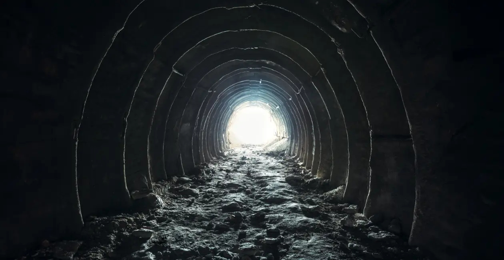 A dark tunnel with a light at the end 