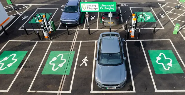 An aerial view of smart charging section of a car park with cars in some of the spaces