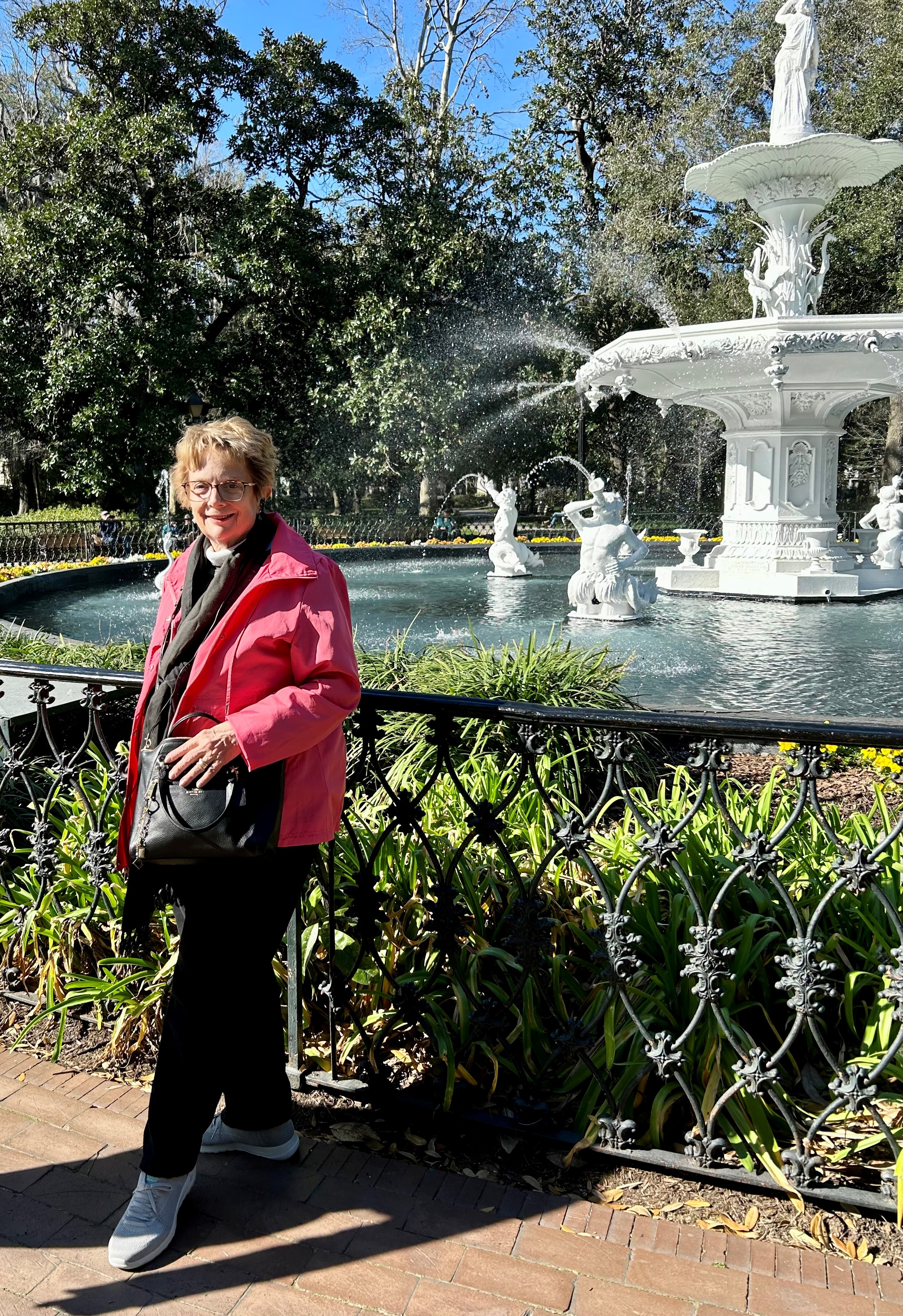 Kathryn stands in front of a white fountain