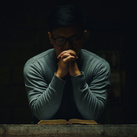 A man spends time in quiet prayer.