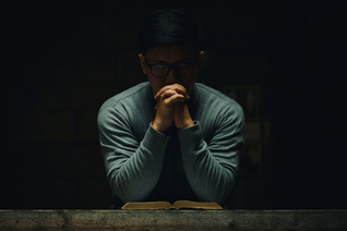 A man spends time in quiet prayer.