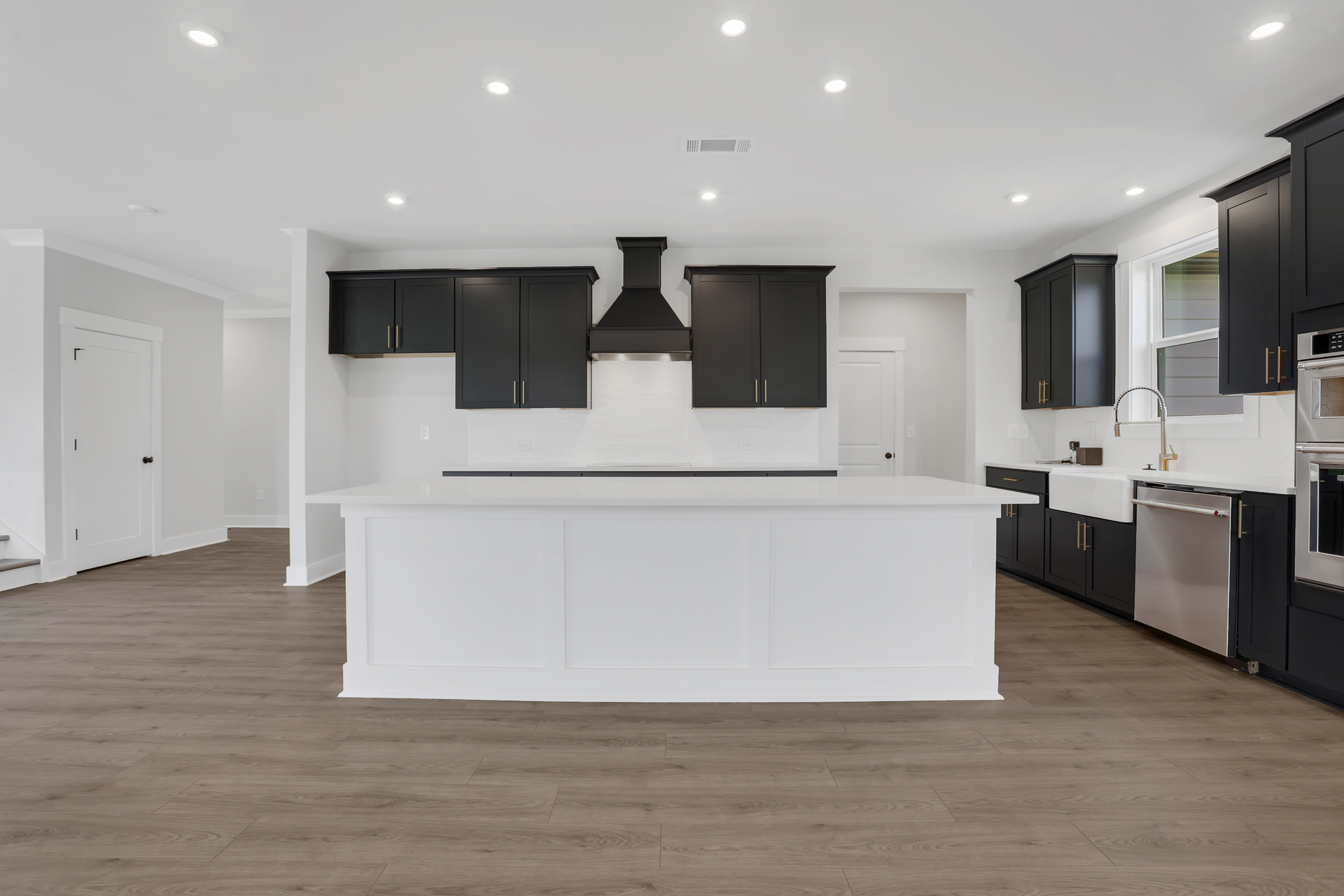 kitchen with dark cabinets and quartz counters