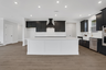kitchen with dark cabinets and quartz counters