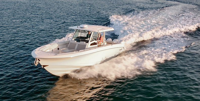 Bows of a large powerboat with onboard Fathom e-power system speeding towards you