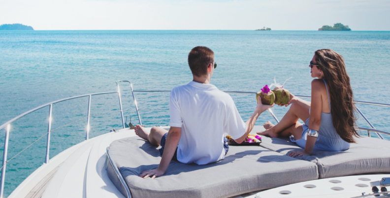 Couple seated on powerboat  with onboard Fathom e-power system