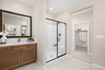 primary bathroom with split sinks and tile floors
