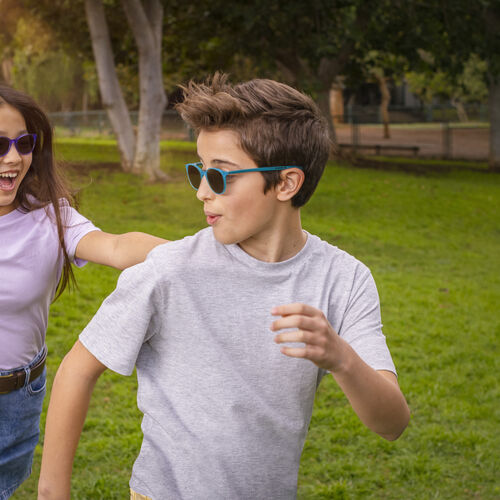 Boy and girl playing outside wearing HOYA MiYOSMART sunglasses