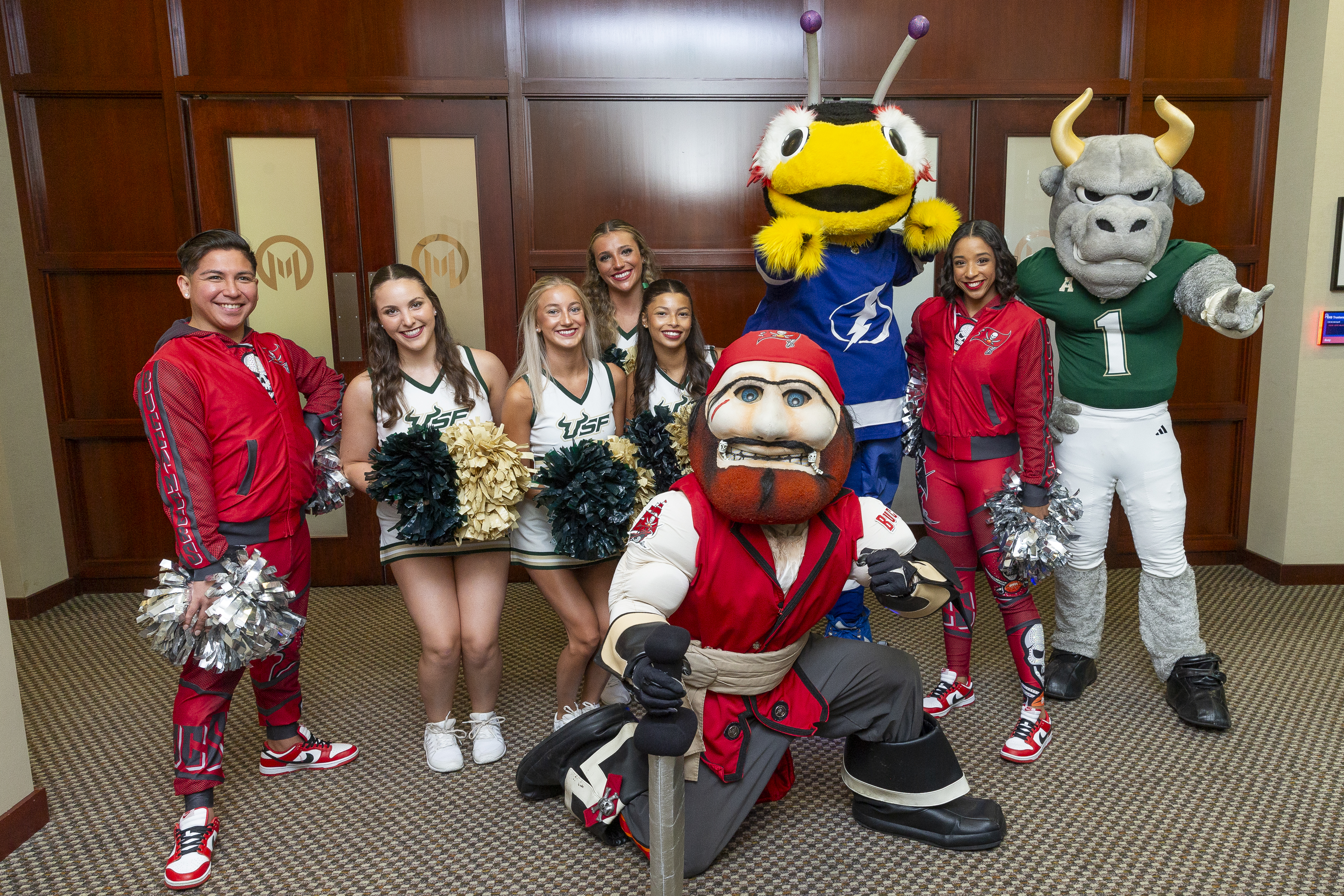 Moffitt patients and team members pose for photos with Tampa Bay sports team mascots and cheerleaders.