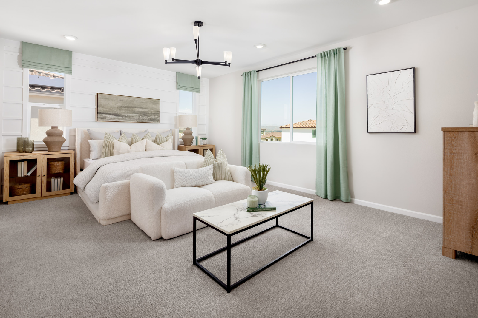 primary bedroom with neutral floors and large windows