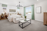 primary bedroom with neutral floors and large windows