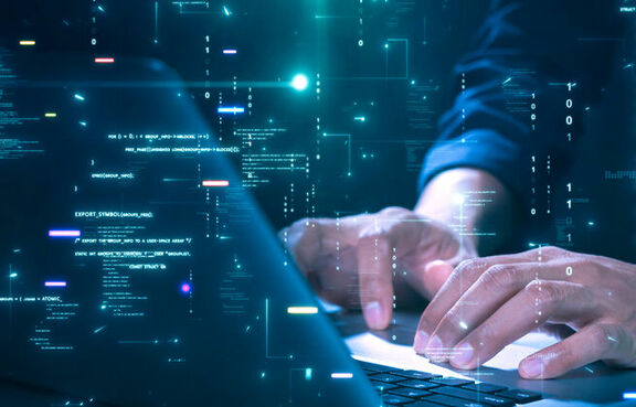 Man working on a laptop with an overlay of code