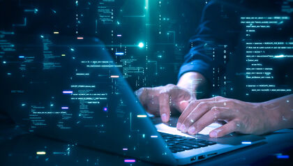 Man working on a laptop with an overlay of code