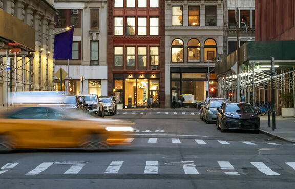 Yellow taxi driving through an intersection