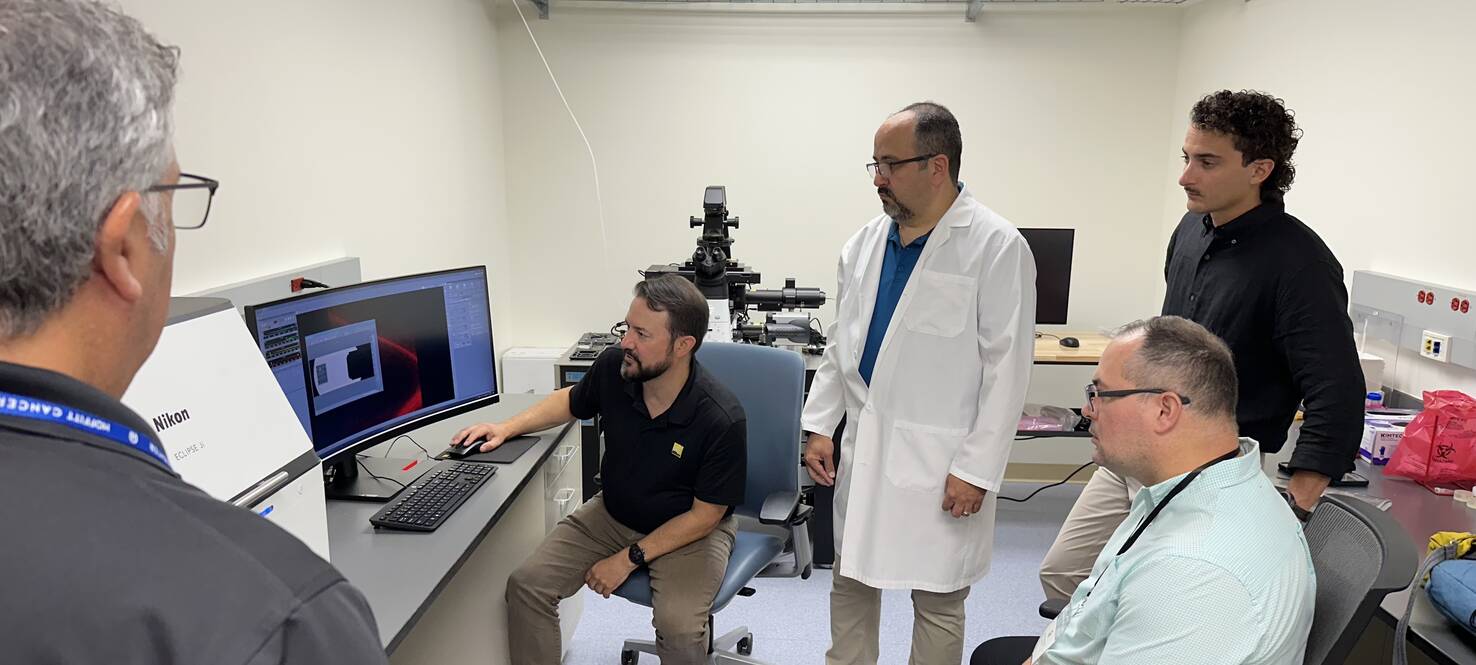 From left: Larry Kordon; Jacob Sawyer, PhD; Jose Serrano-Velez, PhD; Jorge Gomez, DVM; and Bismark Madera Soto explore the capabilities of the Eclipse Ji Smart Imaging System in a lab space at Moffitt Cancer Center’s Nikon Center of Excellence. 
