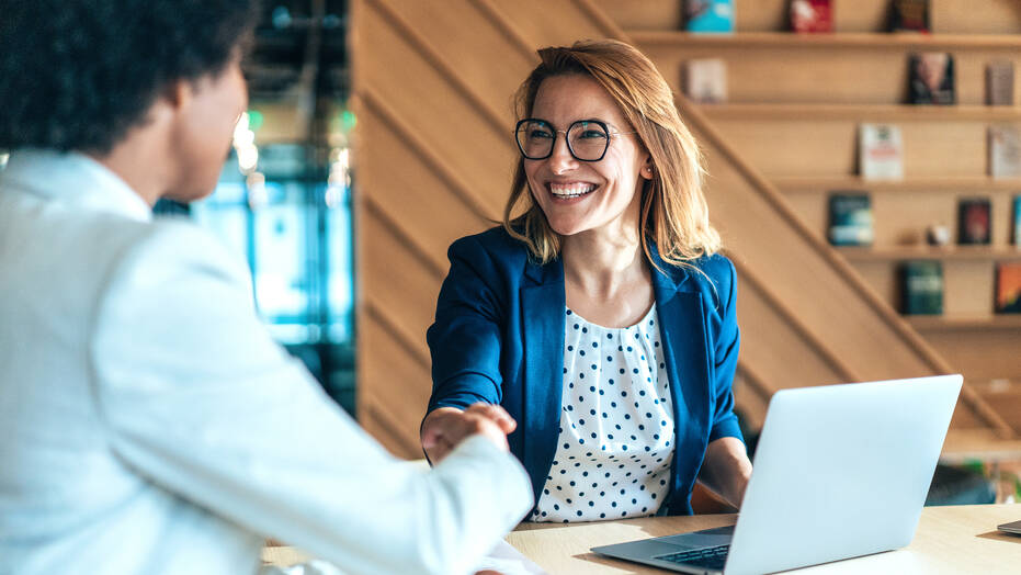 New hire shaking hands with HR manager