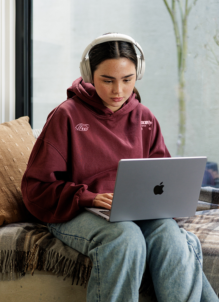 girl on laptop wearing headphones