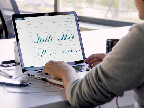 Man looking at a screen of charts