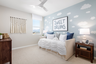 bedroom with neutral carpet and accent wall