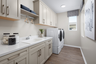 laundry room with neutral floors and large window