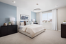 primary bedroom with neutral carpet and large window