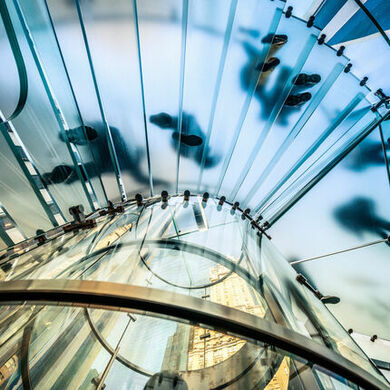 People in motion on glass staircase