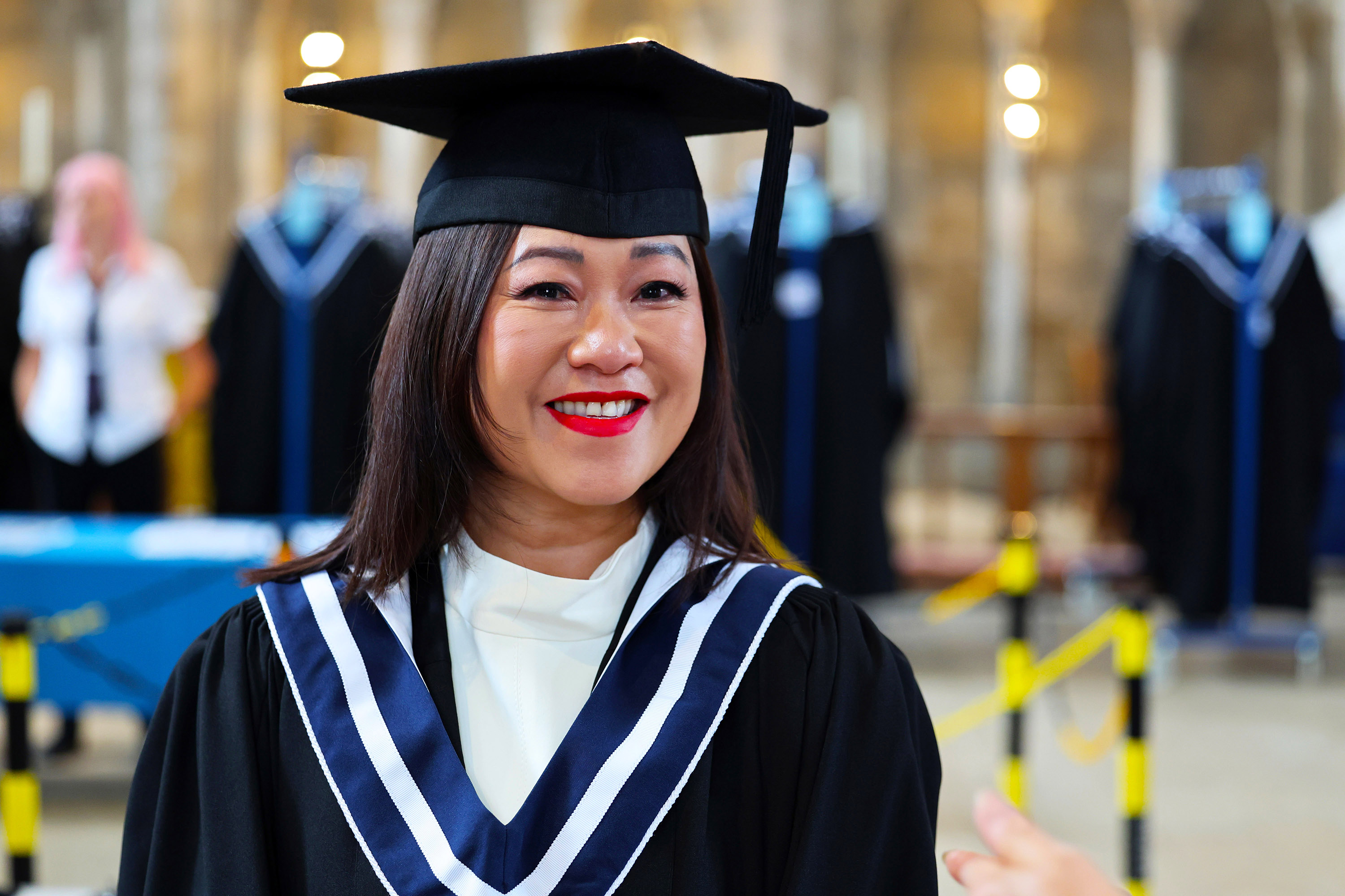 Portrait of a smiling graduate in academic regalia