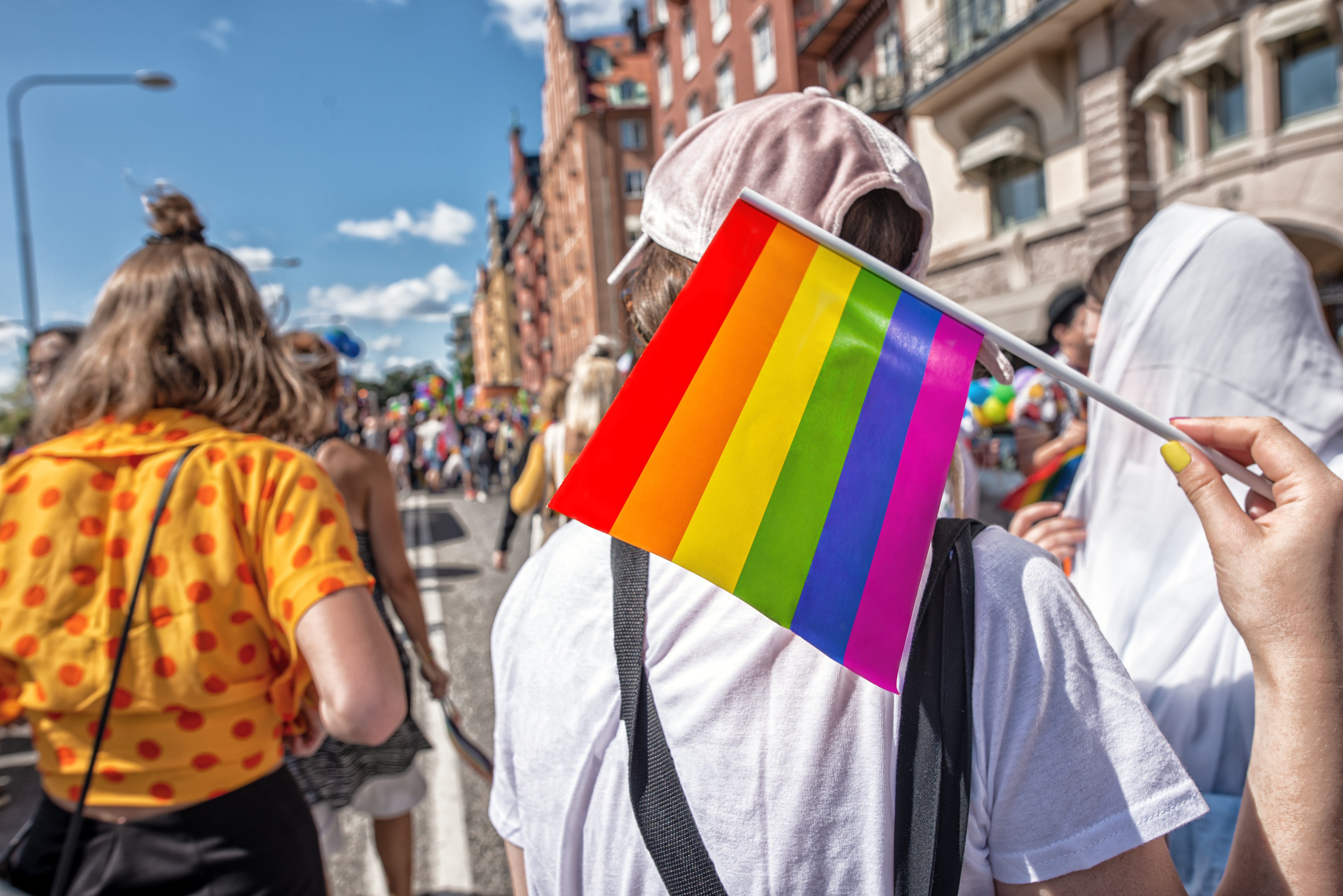 Pride flag in human hand on a pride parade.