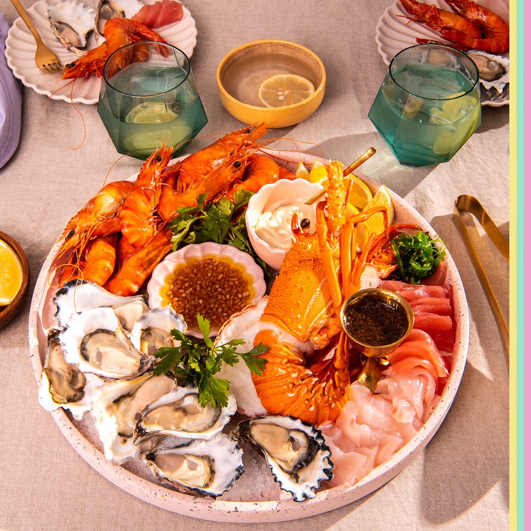 Seafood platter with prawns, oysters, lobster, kingfish and tuna sashimi served with dipping sauce