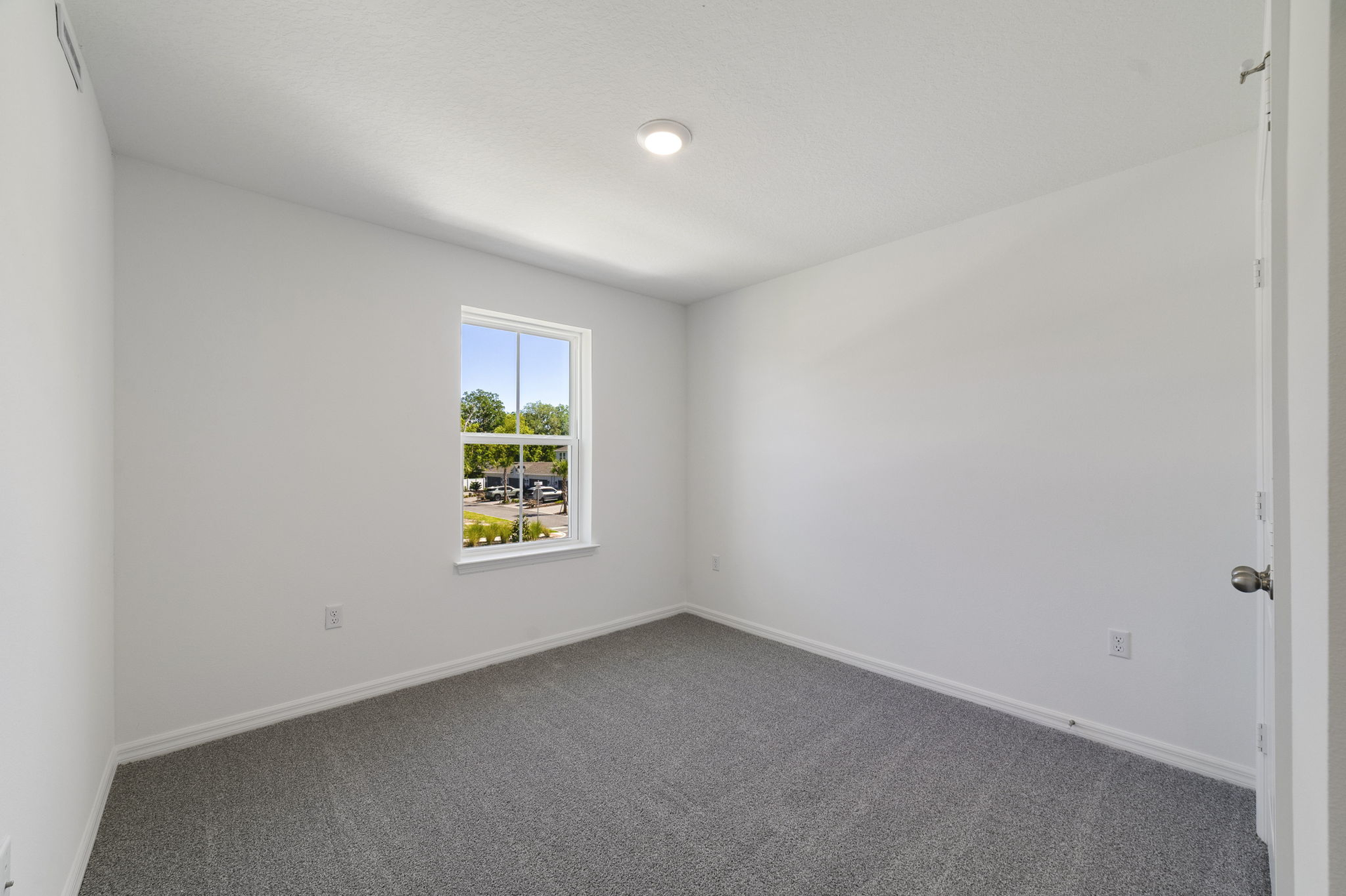 carpet throughout with a single window and closet