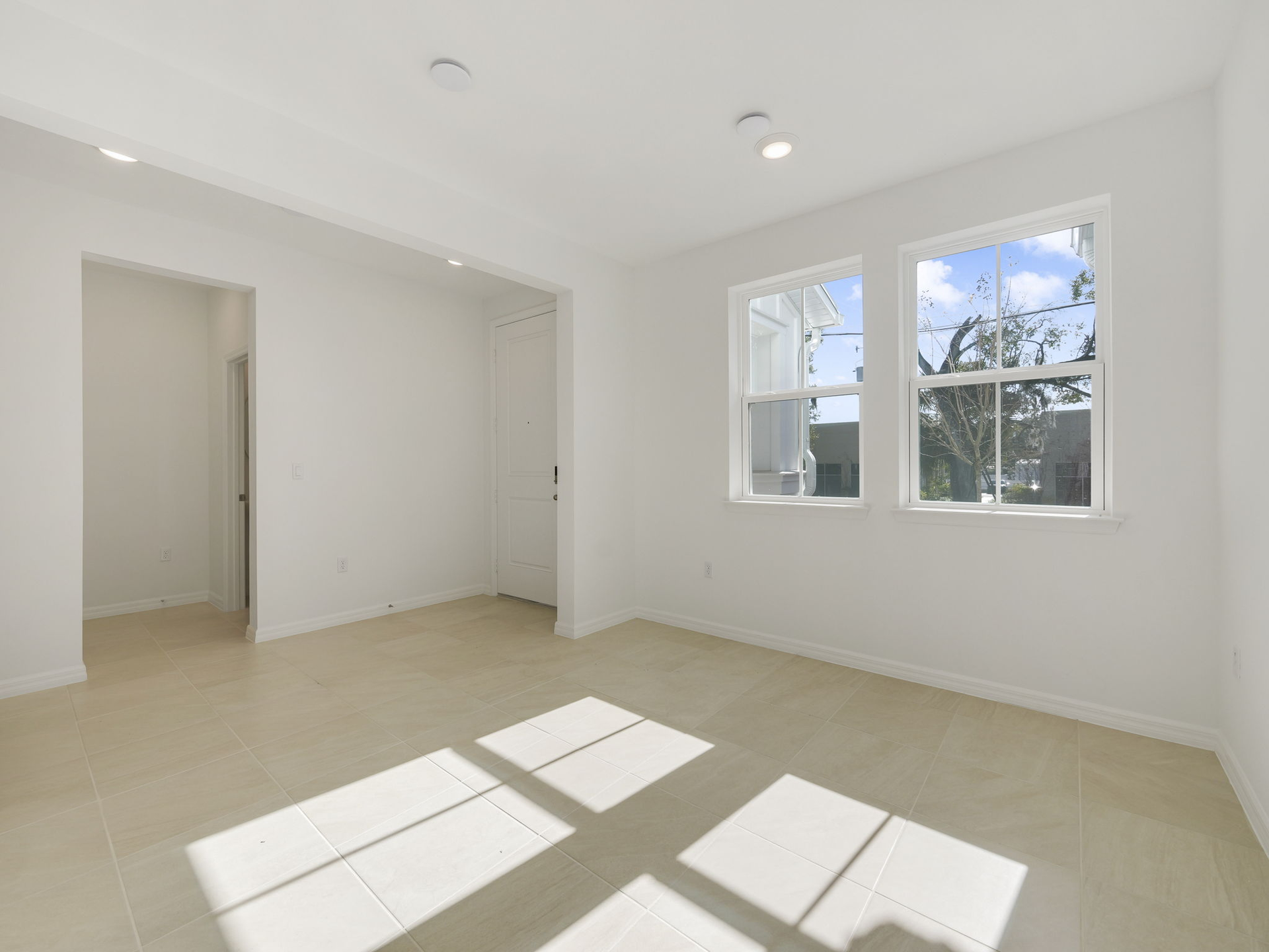 living room with two windows and tile flooring