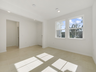 living room with two windows and tile flooring