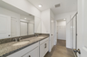 Dual sink vanity with a large mirror and shower