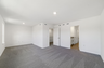 carpet throughout with a sitting room with large windows 