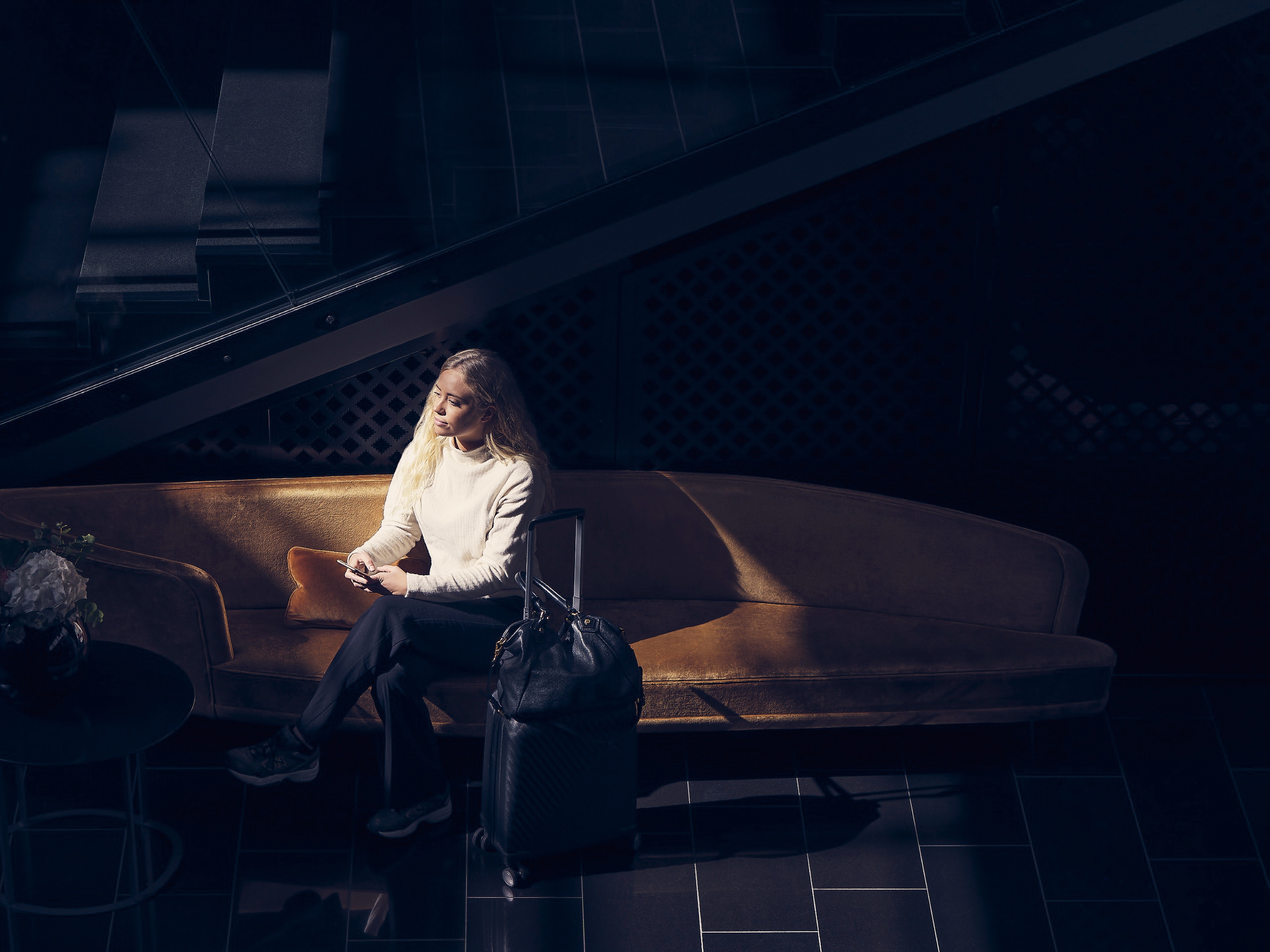 Woman sitting on a couch with a briefcase