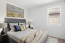 bedroom with a large bed, large white rug, and black wooden nightstands