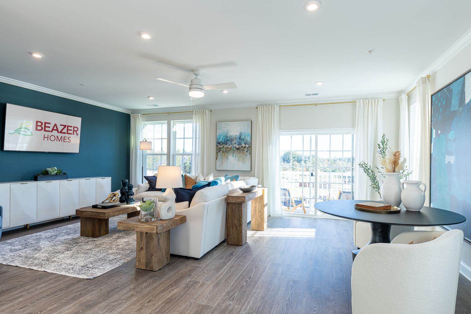 great room with a blue statement wall and white couches