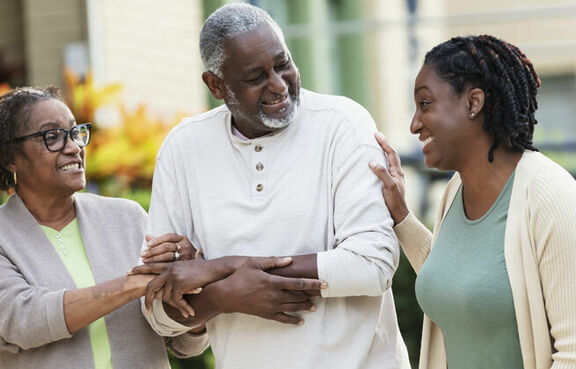 Senior couple walking in front of a care center