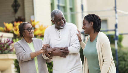 Senior couple walking in front of a care center