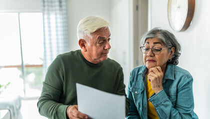 Senior couple using computer and doing home finances