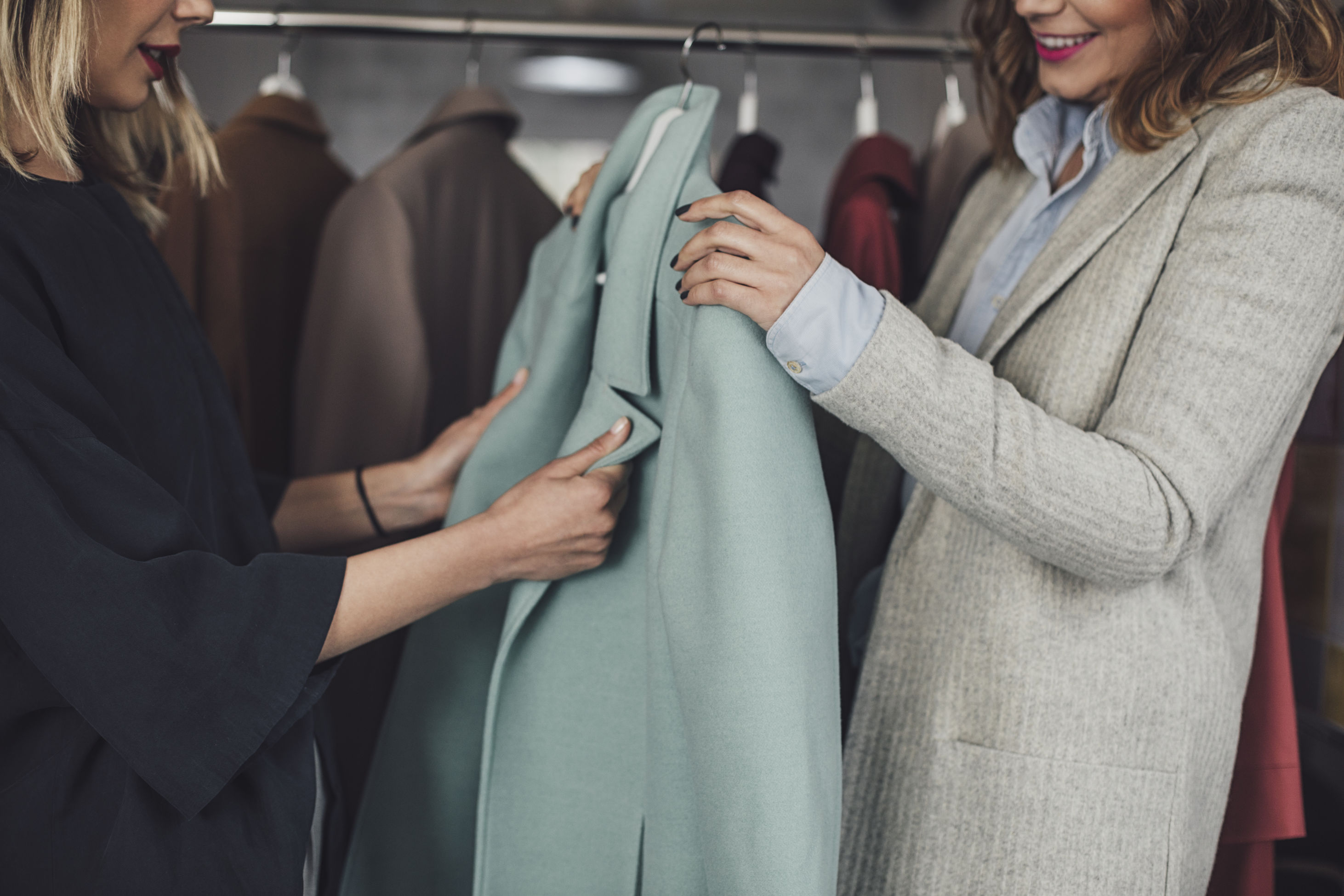 Womens holding clothes