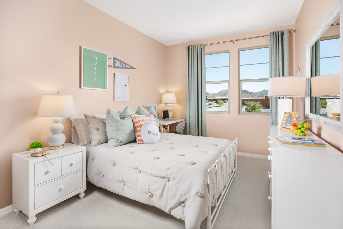 secondary bedroom with bed, wall art, and blinds