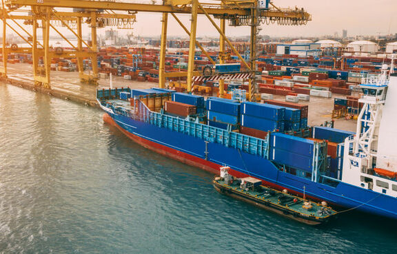 Aerial view of cargo ship and cranes in the harbor