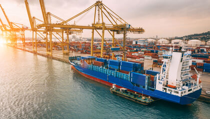 Aerial view of cargo ship and cranes in the harbor