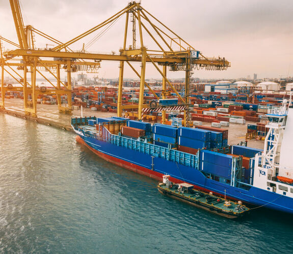 Aerial view of cargo ship and cranes in the harbor