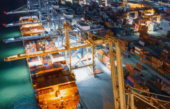 Industrial harbor full of cargo ships at night