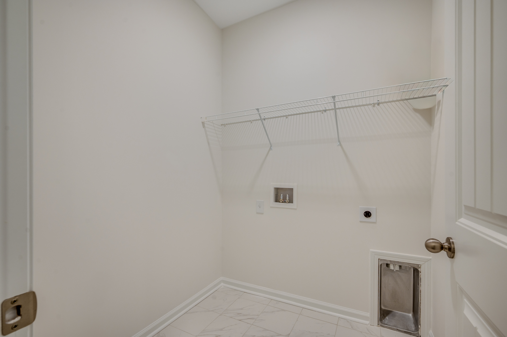 white wire shelving, white wall and tile flooring throughout
