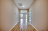 bright entryway with hardwood flooring and tan walls